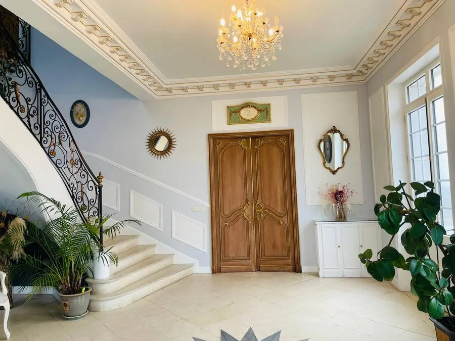 Hall d'entrée monumental avec lustre du Manoir de la Houlette